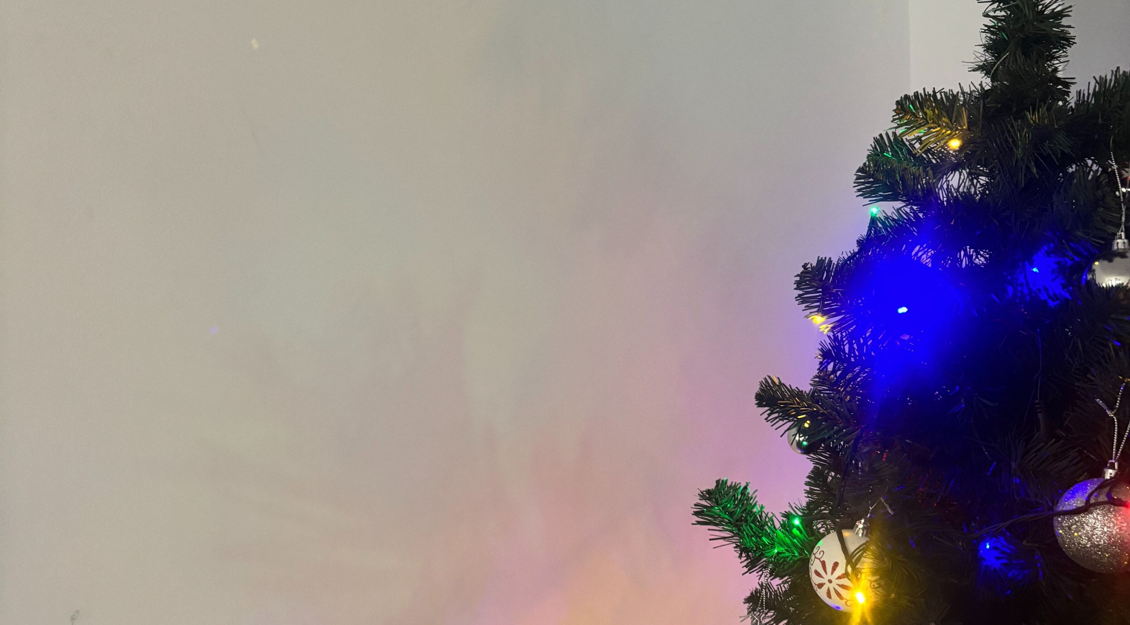 Christmas tree with colorful lights and ornaments at TGLAMHAUS, Peterborough, England, GB.