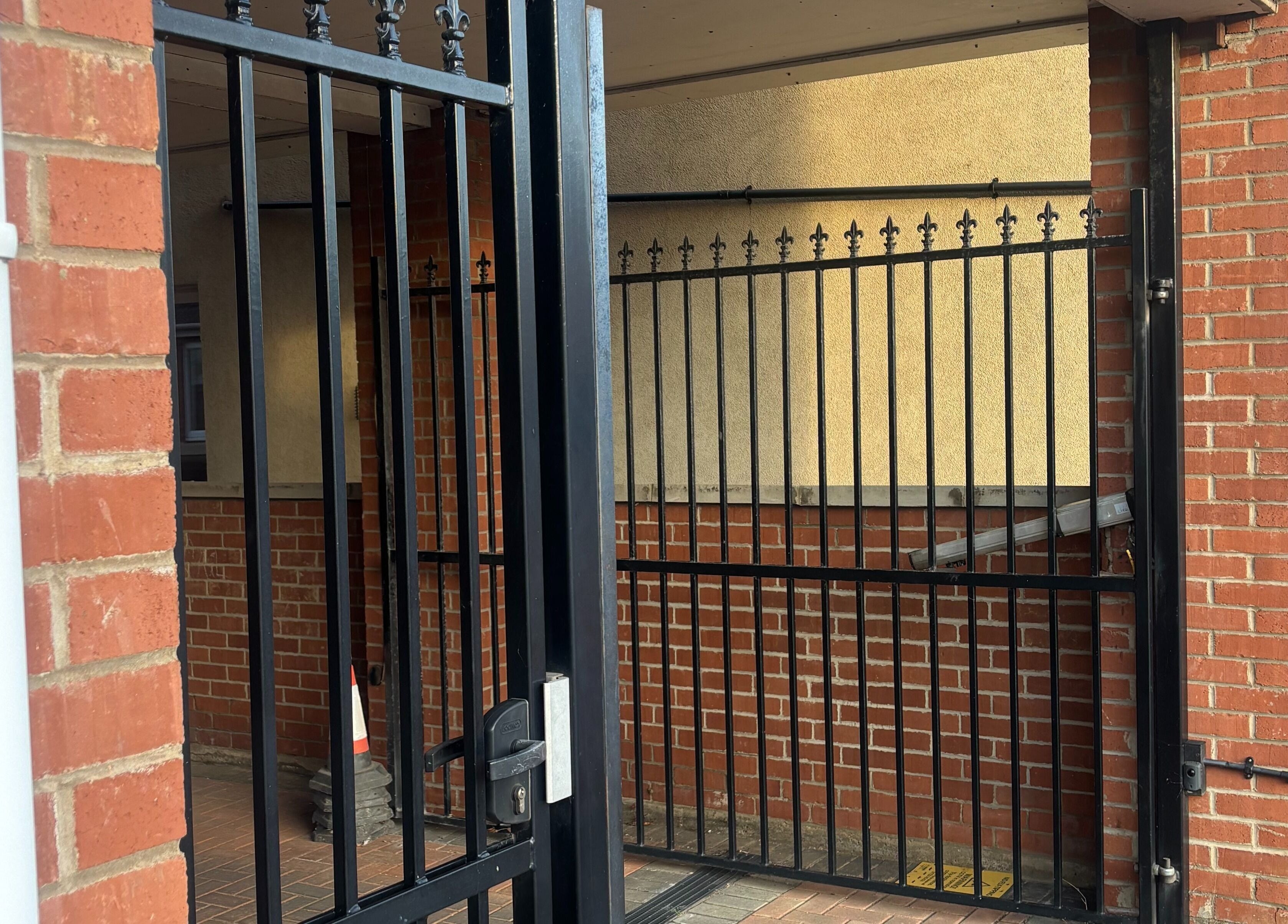 Entrance gate at TGLAMHAUS, Peterborough, England, GB with brick and iron features.