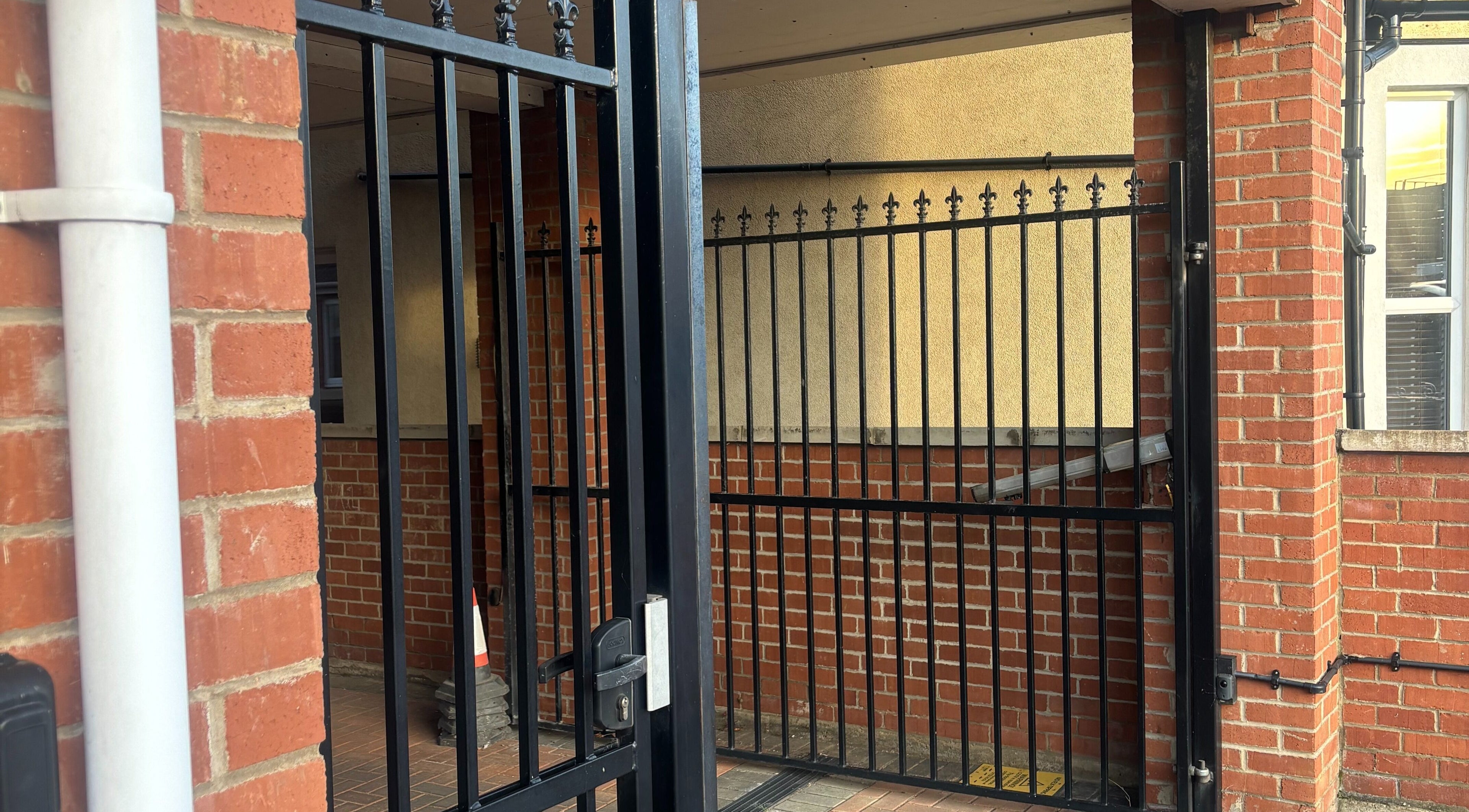 Entrance gate at TGLAMHAUS, Peterborough, England, GB with brick and iron features.