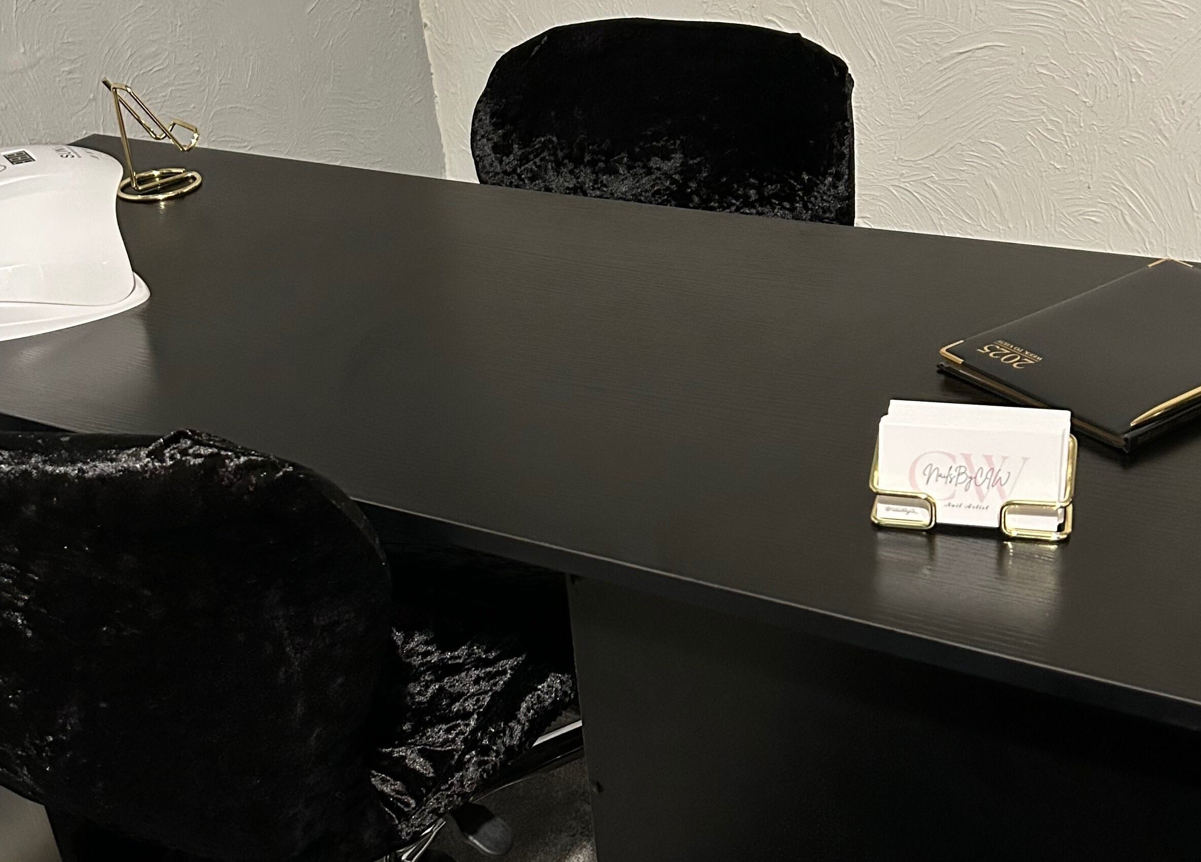 Elegant nail station at Nailsbyci, Stoke-on-Trent, England, GB featuring plush chairs and manicure tools.