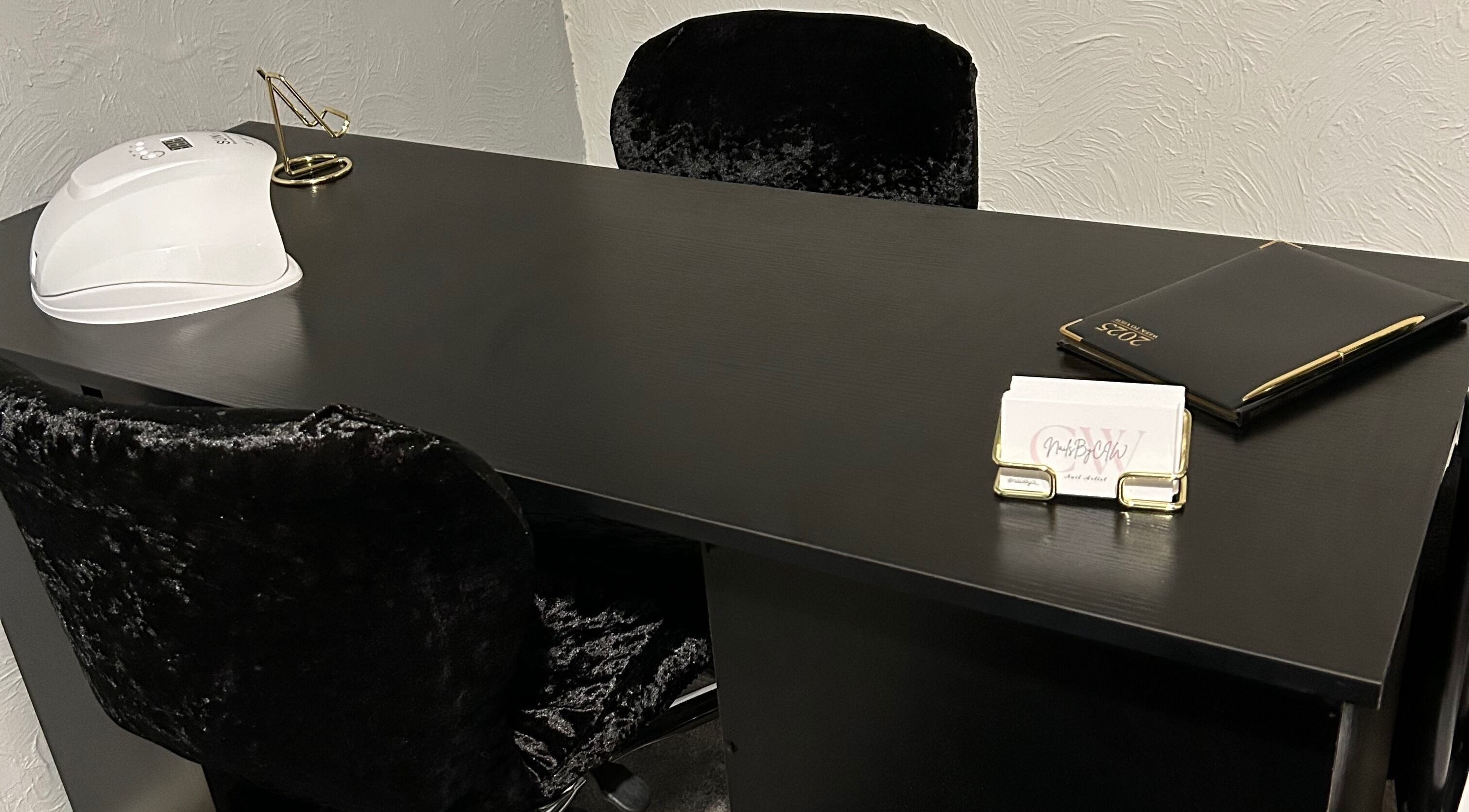 Elegant nail station at Nailsbyci, Stoke-on-Trent, England, GB featuring plush chairs and manicure tools.