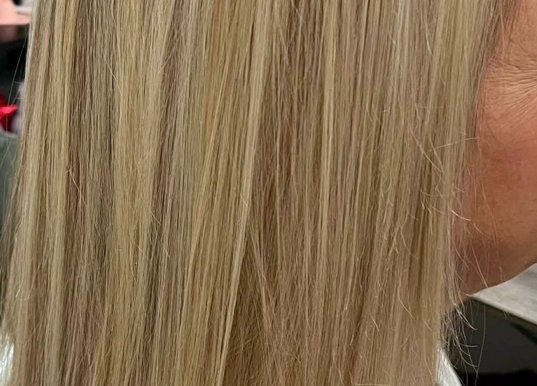 Smooth blonde hair beautifully styled at Hair by Crystal Gayle in Jacksonville, Florida, US.