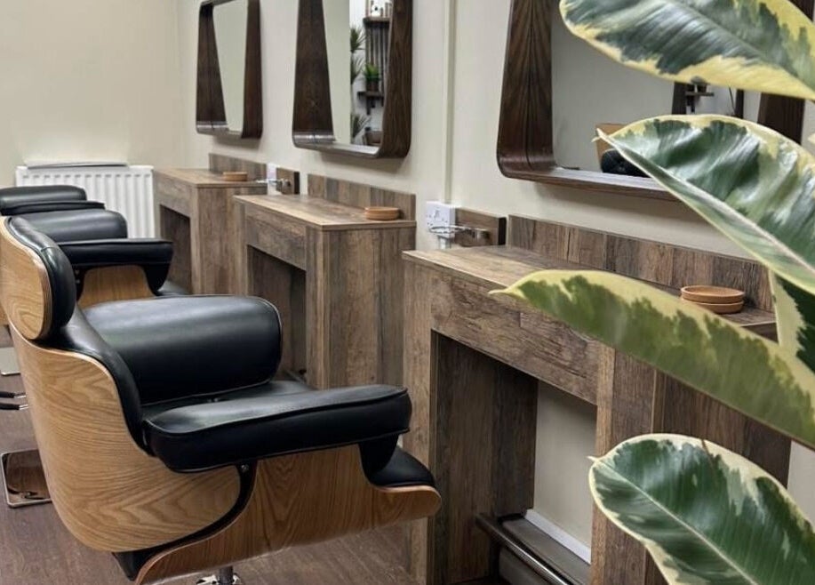 Elegant barber chairs and mirrors at Navie Studio, Hull, England, GB. Modern salon interior.