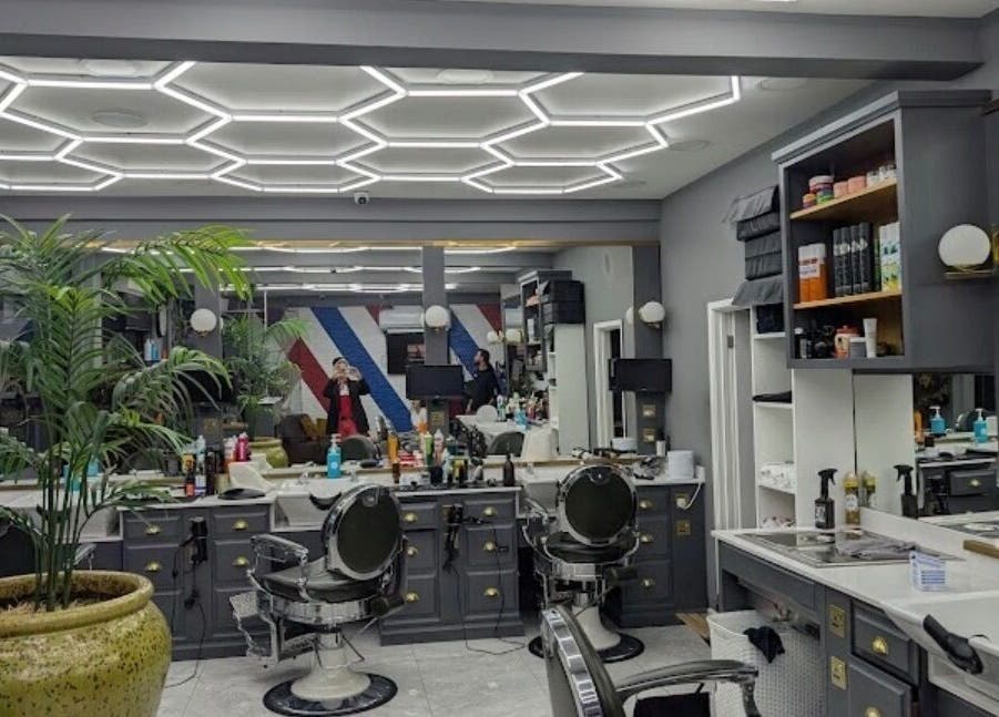Stylish interior of Turkish Barber in Birmingham, England, GB showcasing modern decor and cozy chairs.