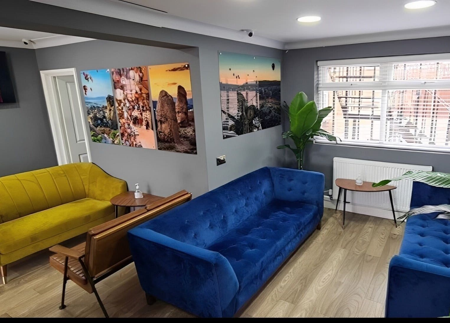Inviting lounge area at Turkish Barber in Birmingham, England, GB with vibrant sofas and wall art.