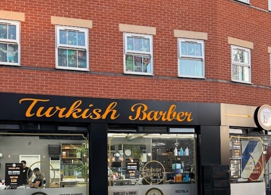 Vibrant facade of Turkish Barber in Birmingham, England, GB, showcasing stylish signage and welcoming storefront.