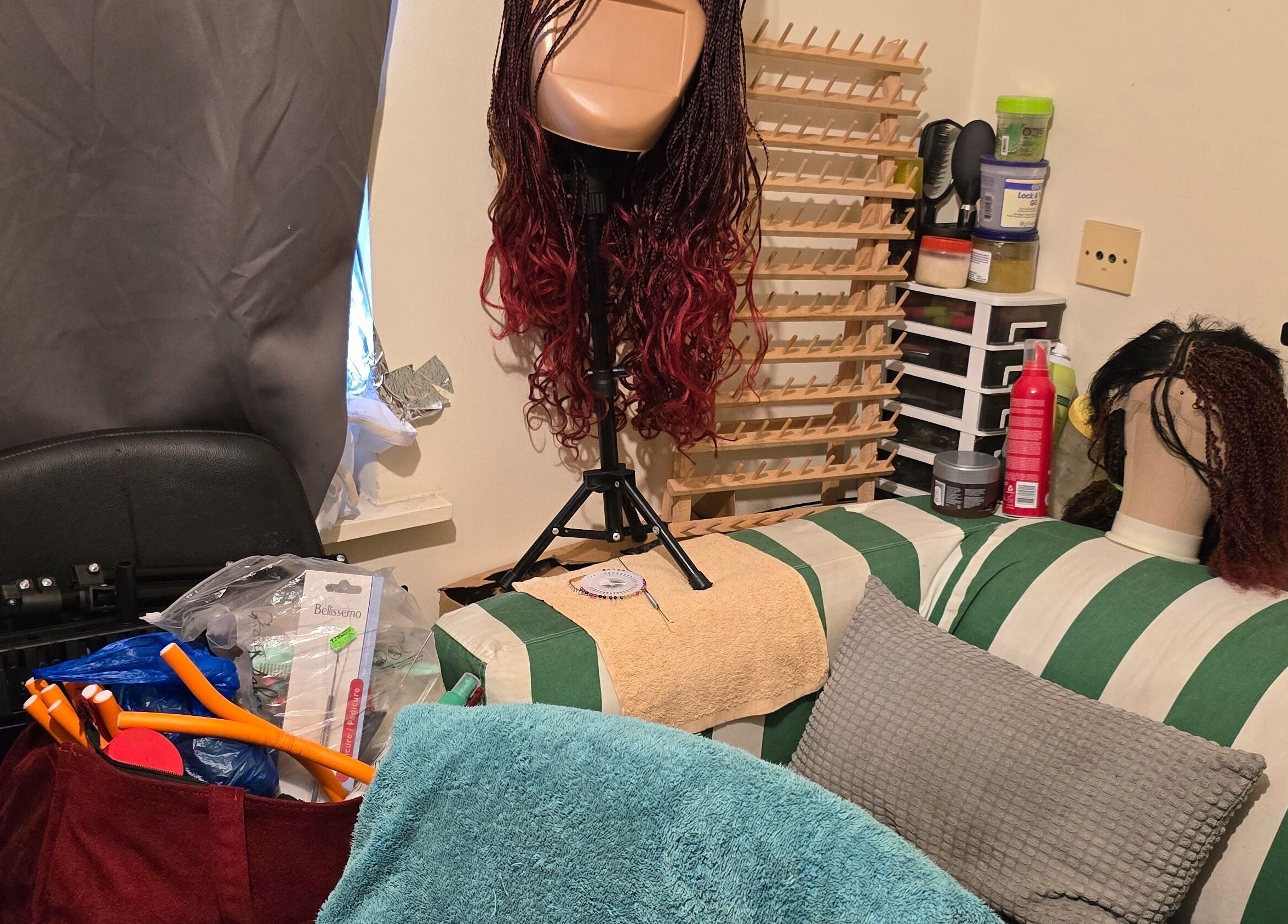 Cozy wig styling setup at Kaffy_houseofbeauty, London, England, GB, featuring styling tools and wigs.