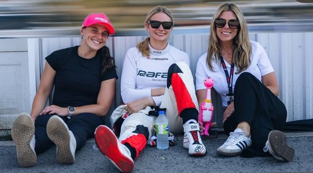 Three women relaxing at a racing event, embodying casual style near Strides Performance, Stamford, Connecticut, US.
