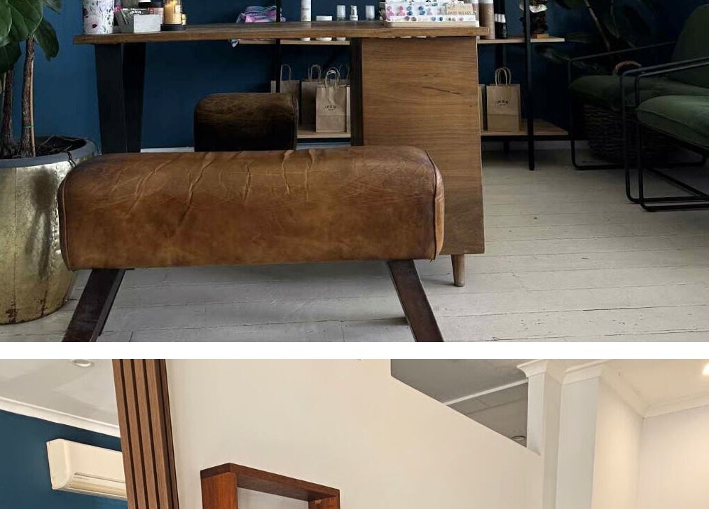 Chic interior of Kutz 4 Kingz, Windsor, Queensland, AU with leather seating and green accents.