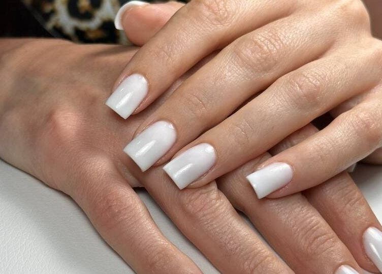 Elegant white manicured nails at DZVINKA Beauty Studio, Edmonton, Alberta, CA.