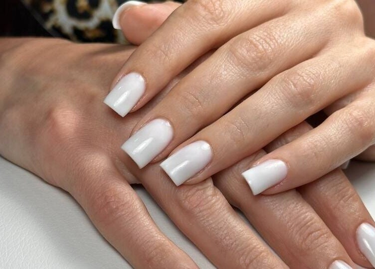 Elegant white manicured nails at DZVINKA Beauty Studio, Edmonton, Alberta, CA.