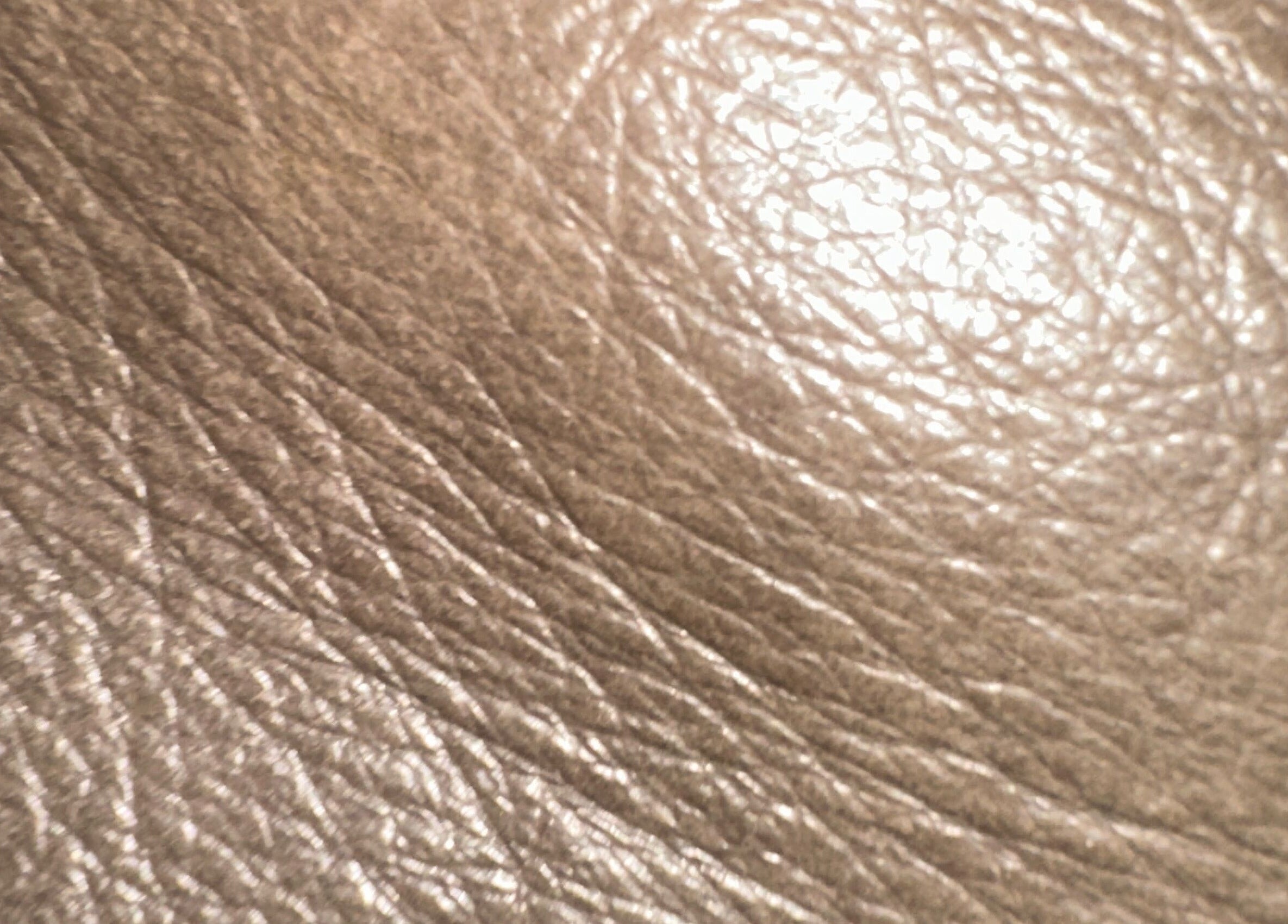 Close-up of beige textured leather at Remy Louis Hair in Manchester, England, GB.