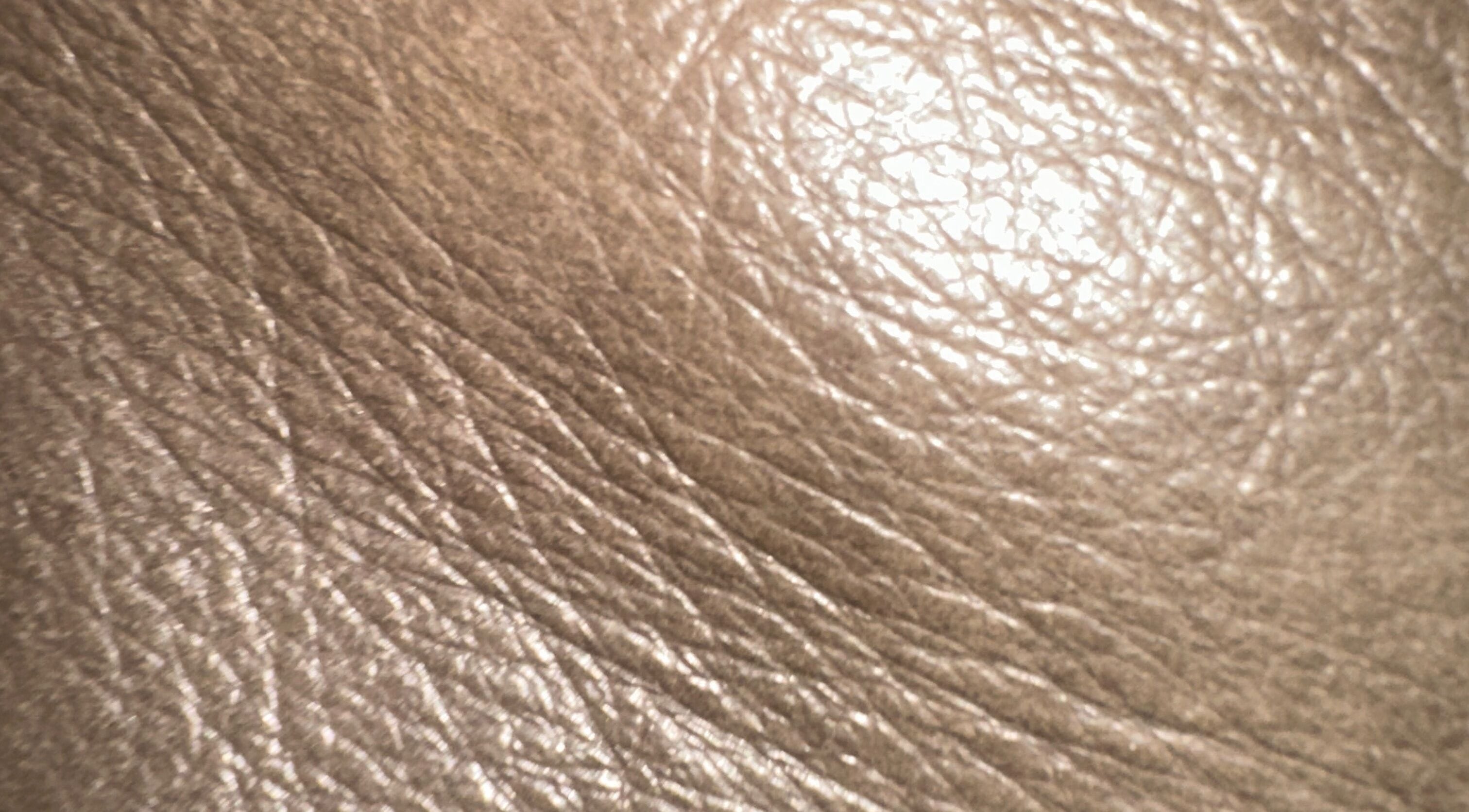 Close-up of beige textured leather at Remy Louis Hair in Manchester, England, GB.