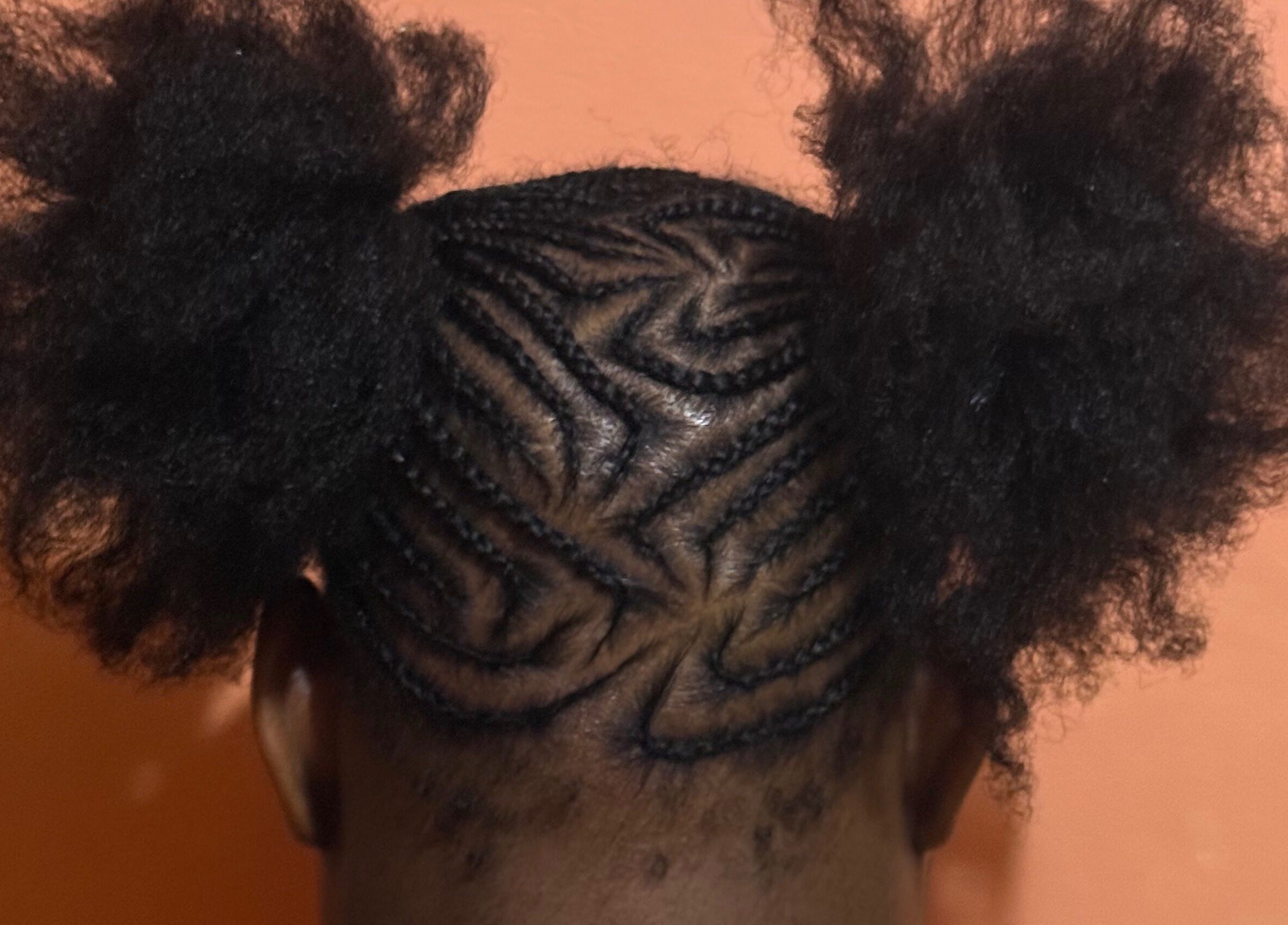 Stylish cornrow braids with puffs at JR Stylez, Montego Bay, St. James Parish, JM.