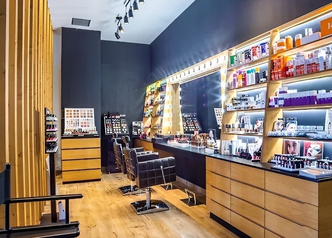 Κομψός χώρος ομορφιάς στο MrandMrsspa, Chalkida, GR με καρέκλες και προϊόντα μακιγιάζ σε ξύλινα ράφια.