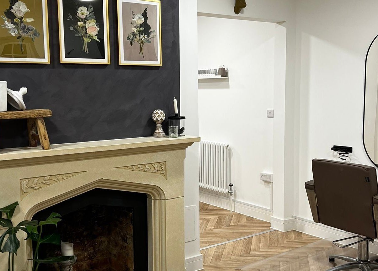 Chic interior of Luxury Locks salon in Oakley, England. Featuring stylish decor and modern salon chair.