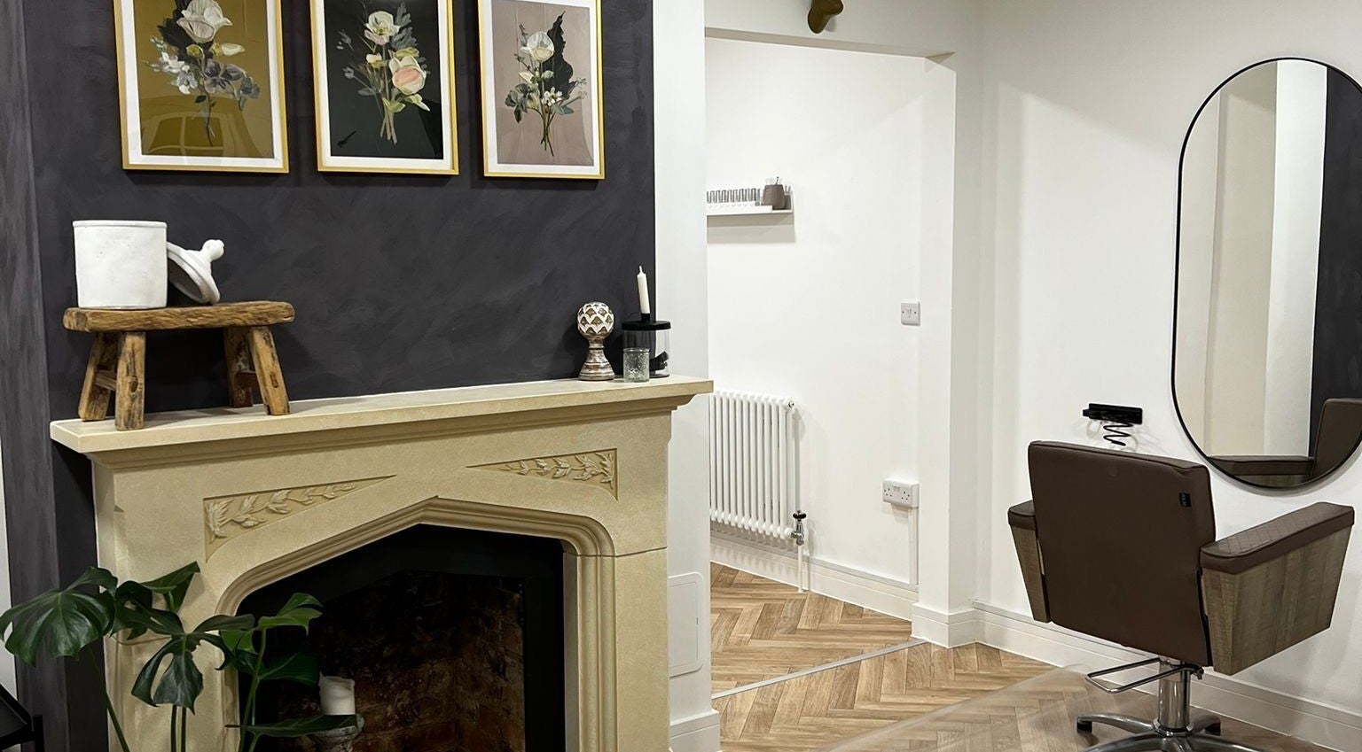 Chic interior of Luxury Locks salon in Oakley, England. Featuring stylish decor and modern salon chair.
