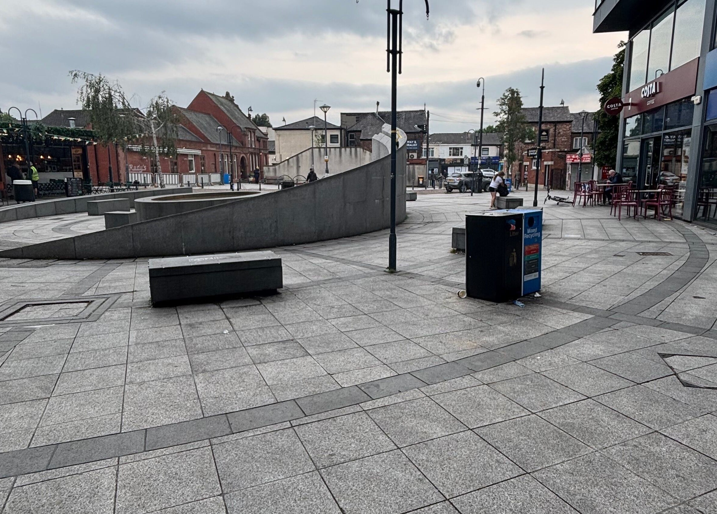 View of bustling square near Ej beauty service in Prestwich, England, GB with modern architecture.