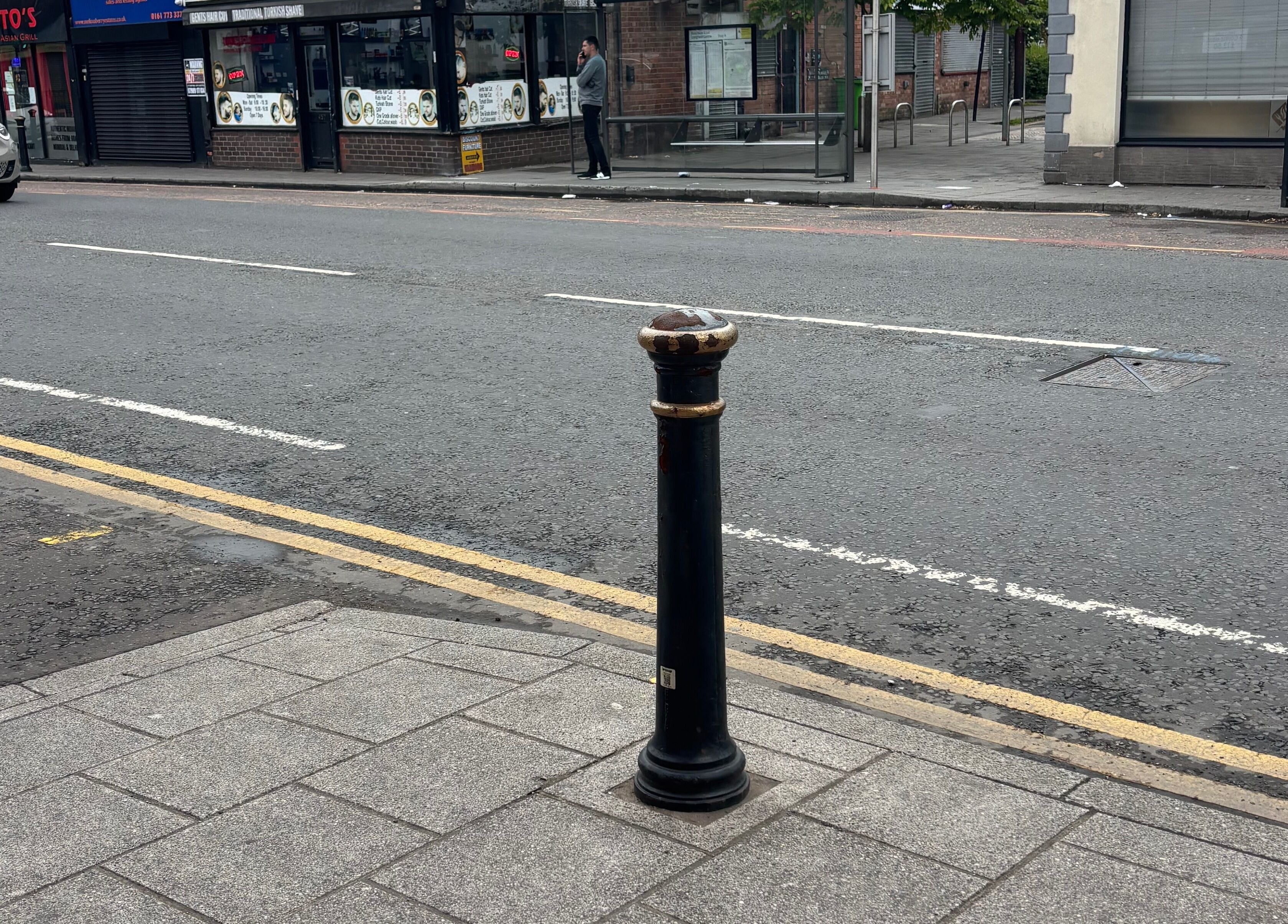 Ej beauty service location in Prestwich, England, GB near urban street with bollard and storefronts.