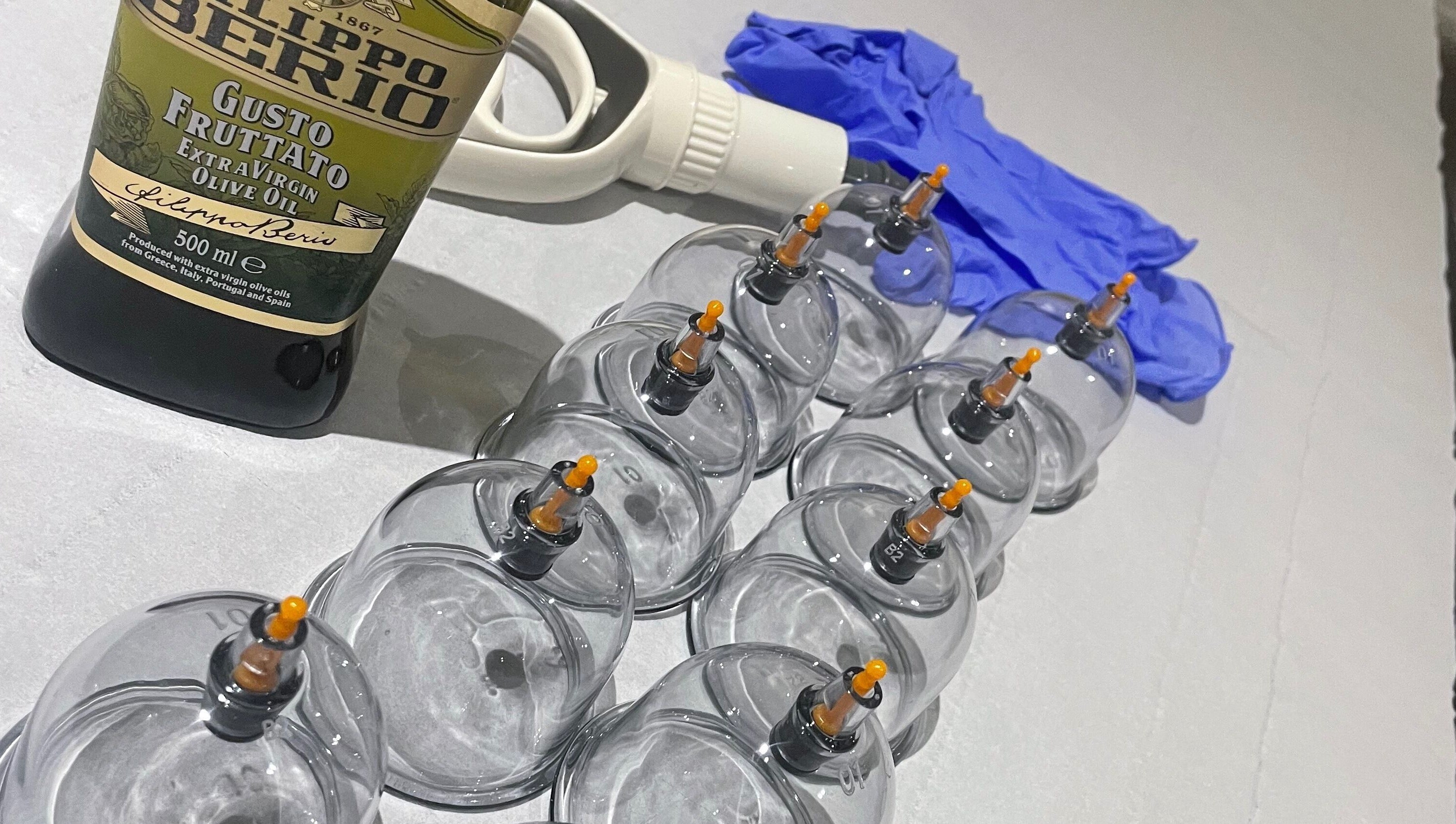 Cupping tools at Cupping By Hamza, Adlington, England, GB, including cups, olive oil, and gloves.