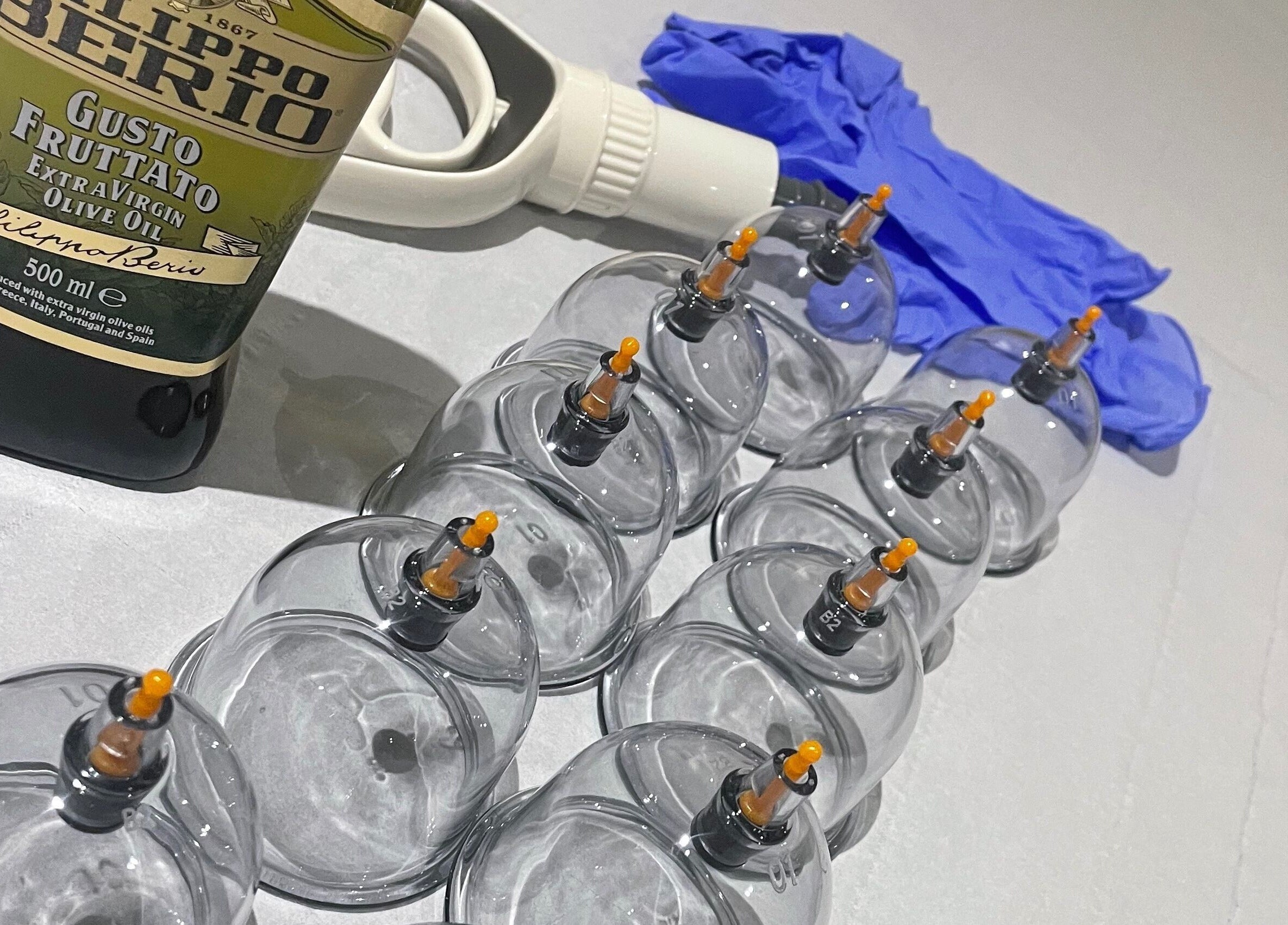 Cupping tools at Cupping By Hamza, Adlington, England, GB, including cups, olive oil, and gloves.