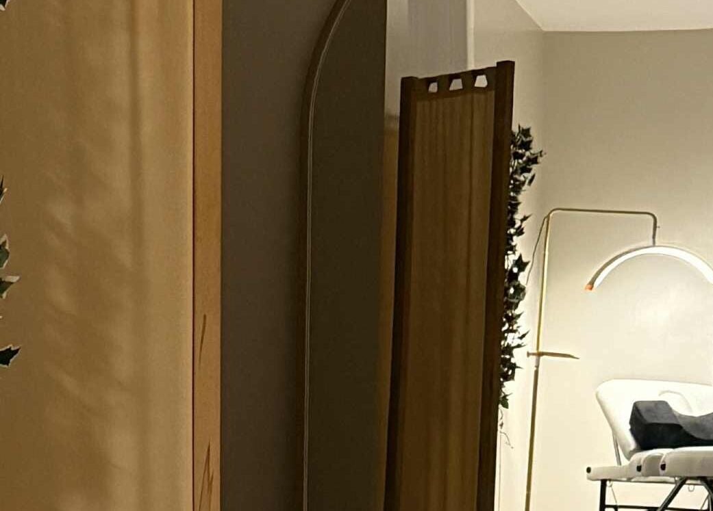 Relaxing treatment room at The Beauty Lab, Newark-on-trent, England, GB with a treatment bed and ambient lighting.