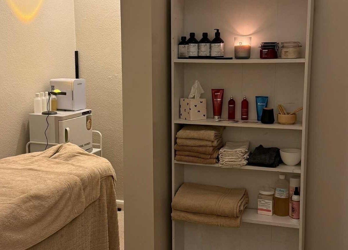 Cozy treatment room at The Beauty Lab, Newark-on-Trent, England, GB. Shelves with products and soft towels.