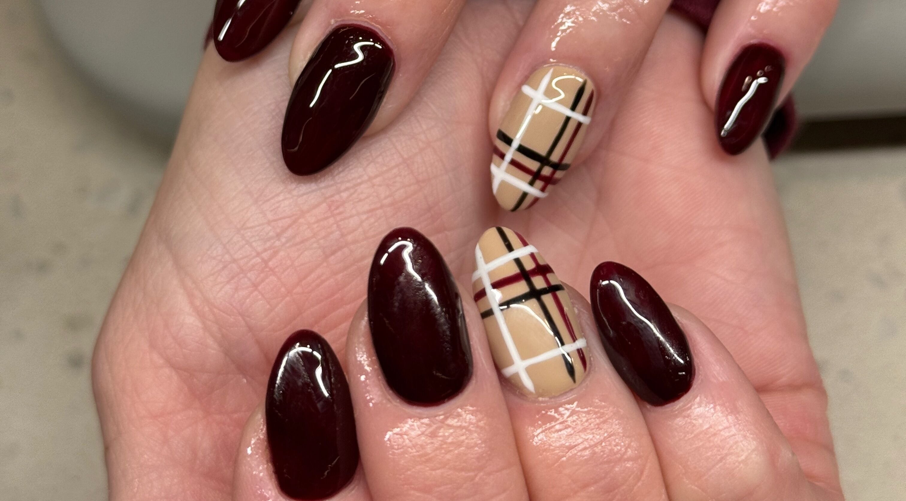 Elegant burgundy and plaid nail art by Nails by Orion in Port St. Lucie, Florida, US.