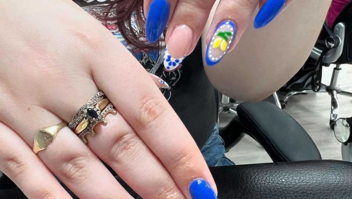 Bright blue and floral nail art at Nail Express Tewkesbury, Tewkesbury, England, GB.