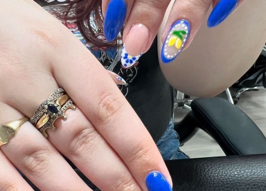 Bright blue and floral nail art at Nail Express Tewkesbury, Tewkesbury, England, GB.