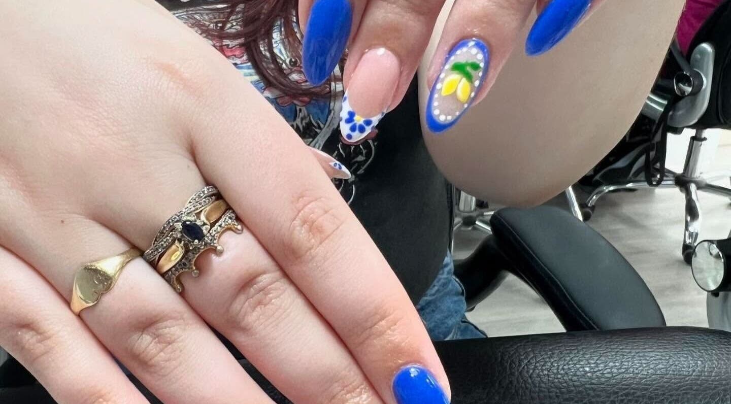 Bright blue and floral nail art at Nail Express Tewkesbury, Tewkesbury, England, GB.