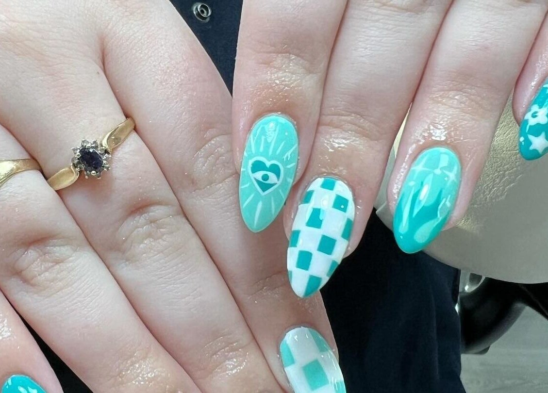 Intricate teal nail designs at Nail Express Tewkesbury, Tewkesbury, England, GB featuring stars and hearts.