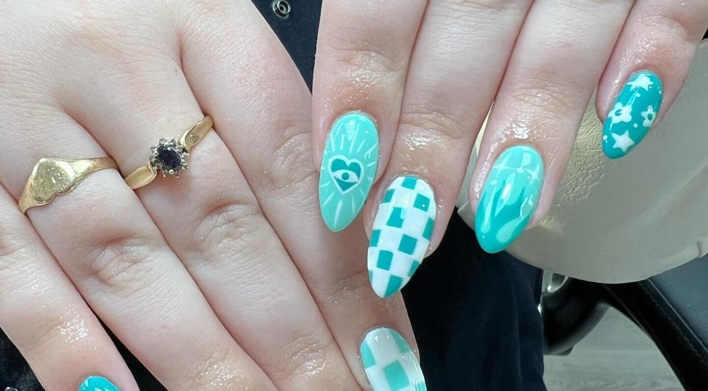 Intricate teal nail designs at Nail Express Tewkesbury, Tewkesbury, England, GB featuring stars and hearts.