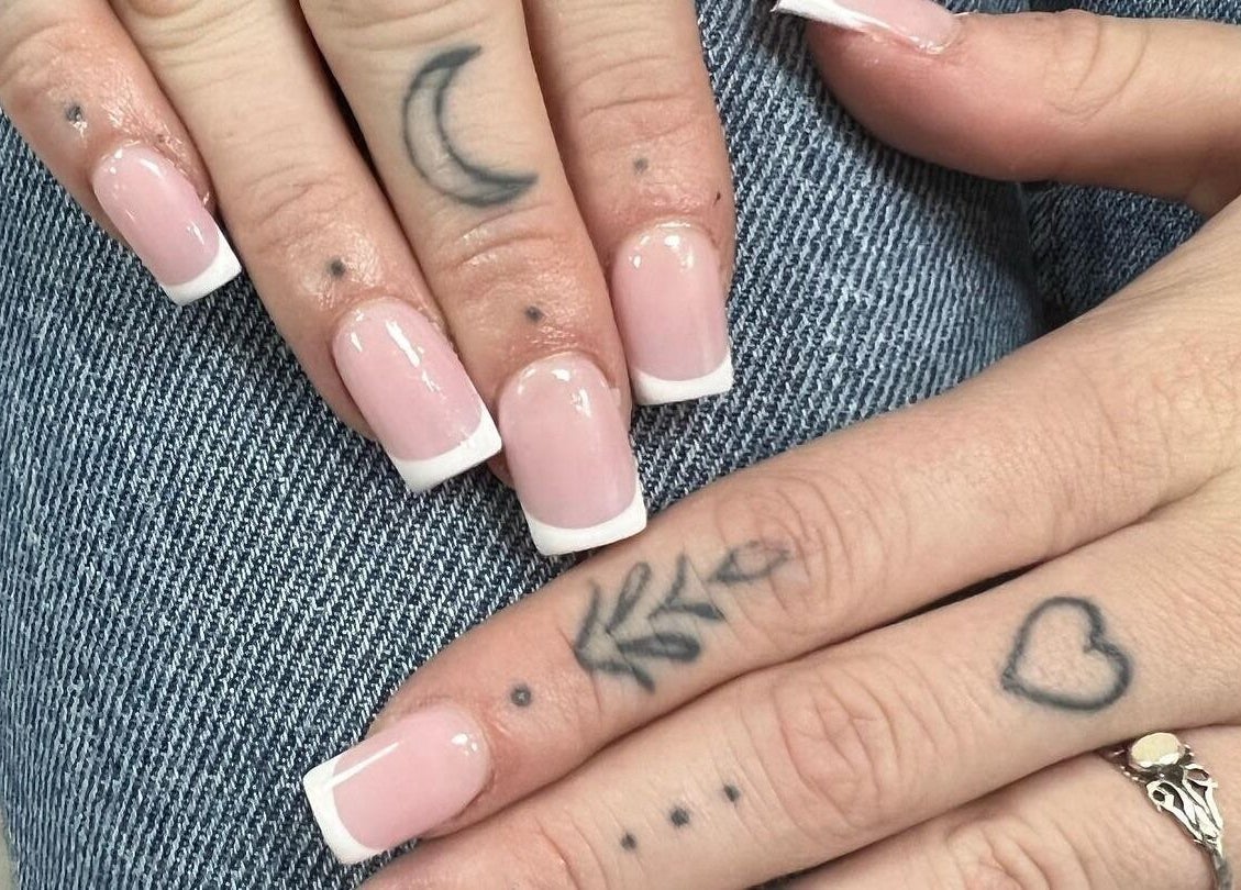 Stylish French manicure and tattoos at Nail Express Tewkesbury, Tewkesbury, England, GB.