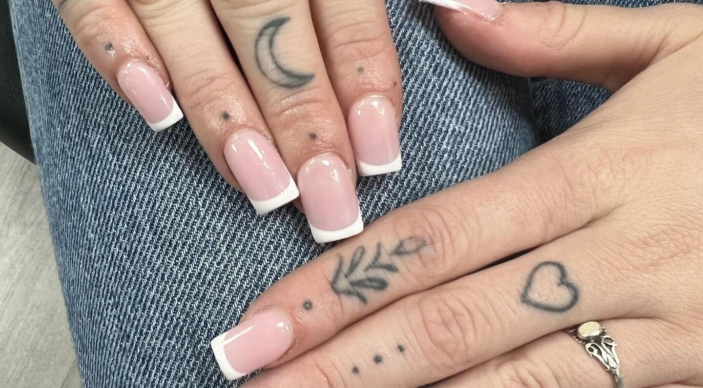 Stylish French manicure and tattoos at Nail Express Tewkesbury, Tewkesbury, England, GB.