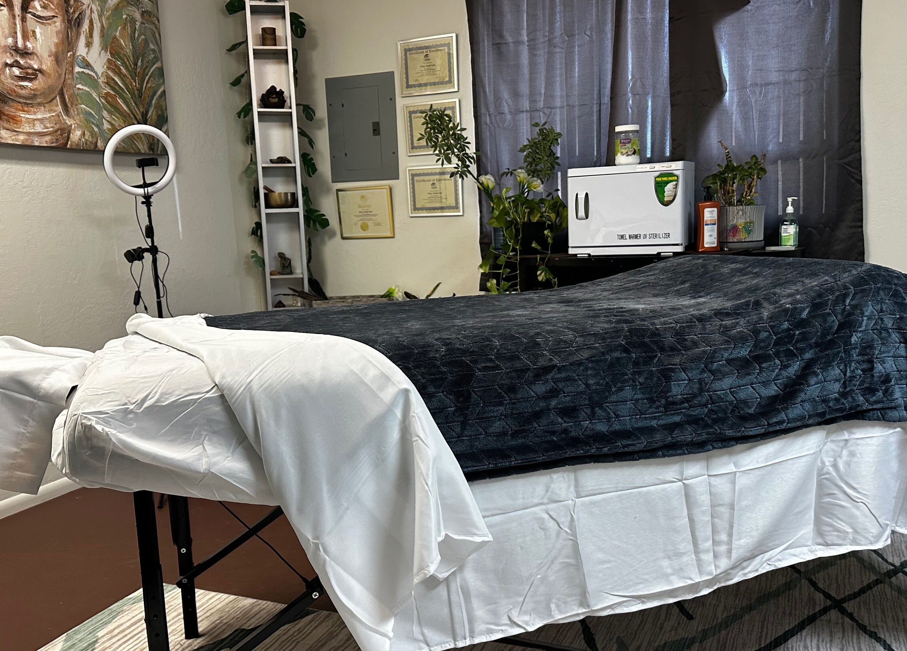 Calming massage room at Tina Andersen, Cottonwood, Arizona, US with art and plush linens.