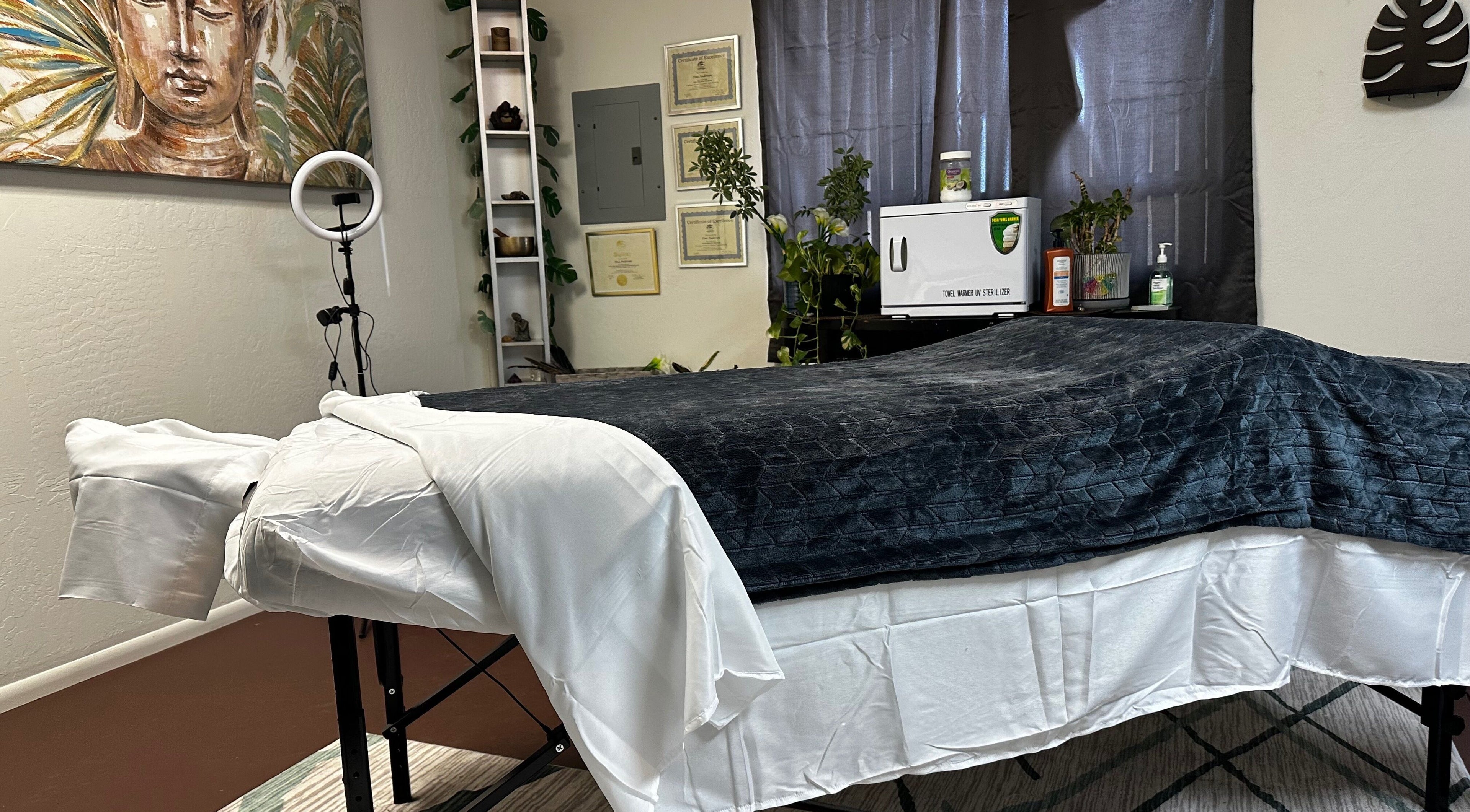 Calming massage room at Tina Andersen, Cottonwood, Arizona, US with art and plush linens.
