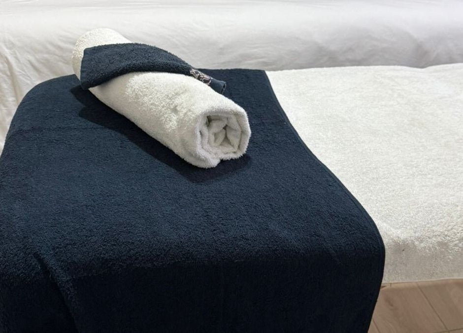 Luxurious massage table setup with soft towels at Lilly Harmony & Sparkle, Sandton, ZA.