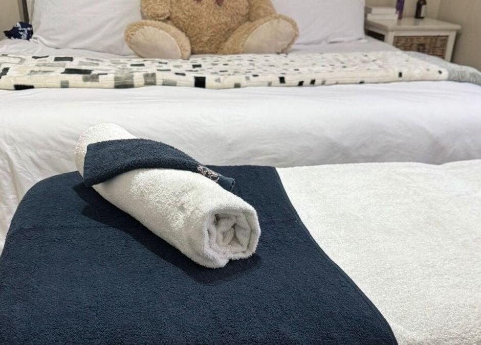 Cozy spa bed setup at Lilly Harmony & Sparkle, Midrand, Gauteng, ZA featuring plush linens and a rolled towel.
