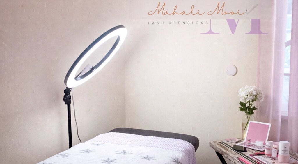 Mahali Mooi lash extension room with bed and floral decor in Portmore, St. Catherine Parish, JM.