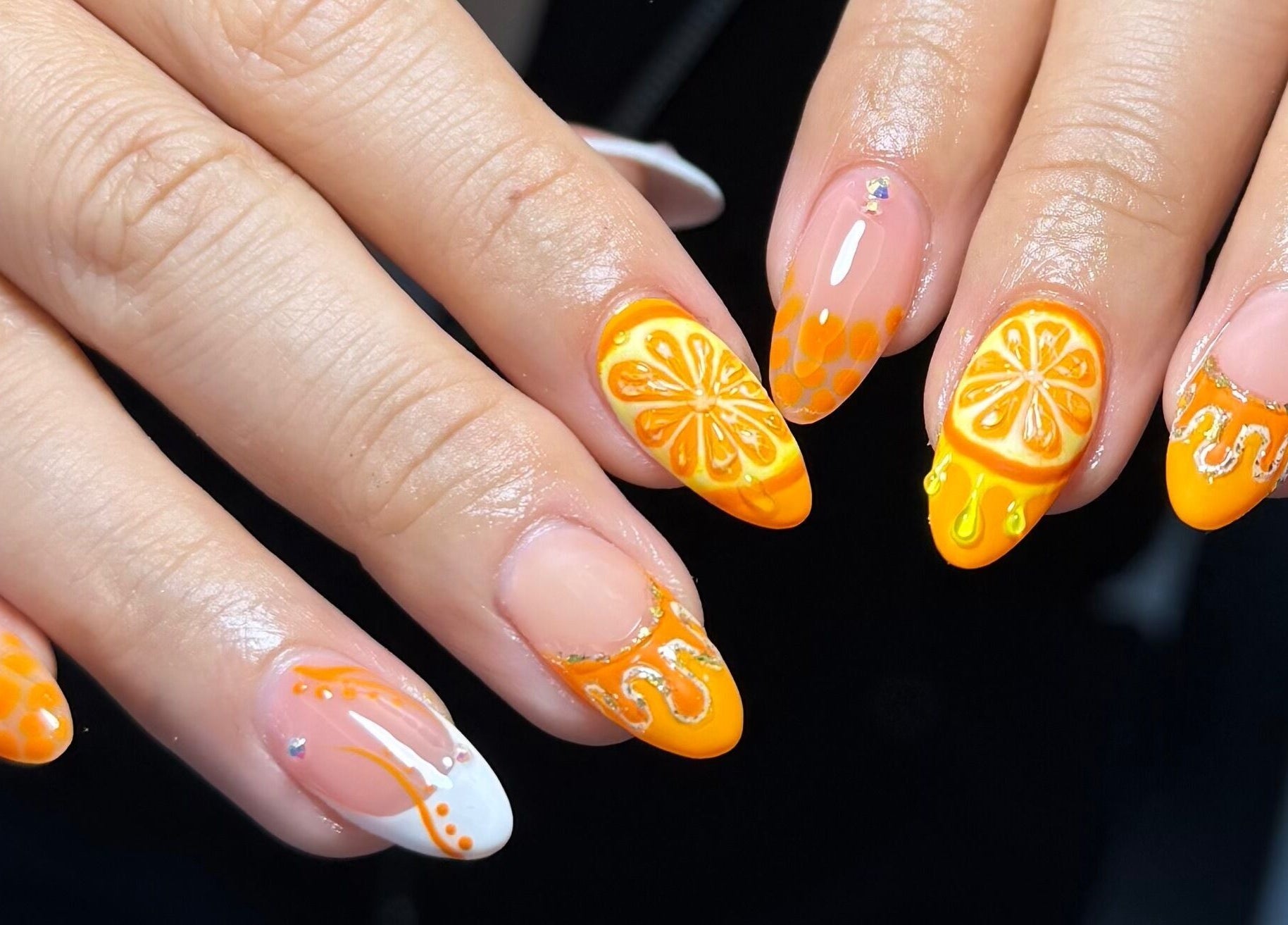 Orange citrus-themed nail art at Harmonia Beauty, Prahran, Victoria, AU showcasing intricate designs.