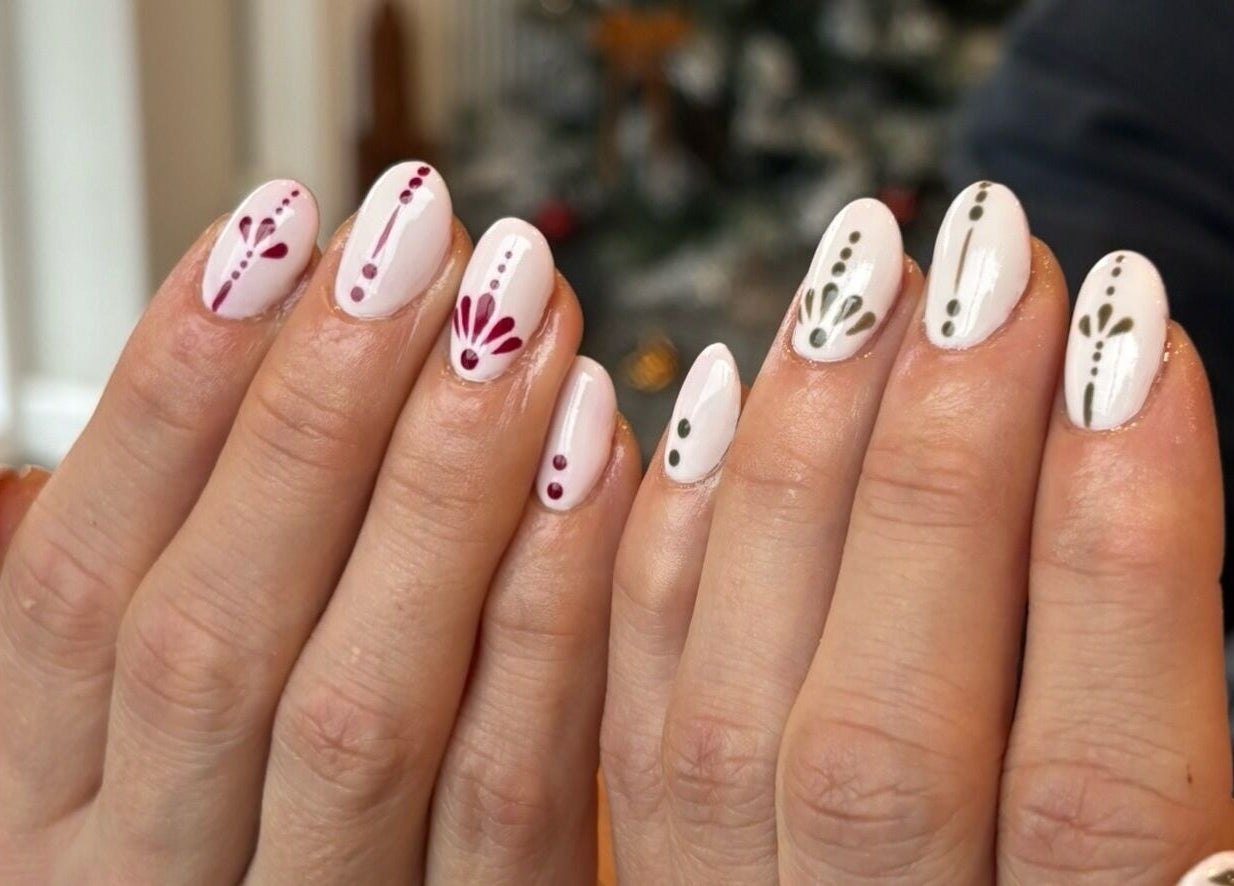 Detailed nail art with red and green accents at Fine Little Things Studios, Bury St Edmund’s, England, GB.