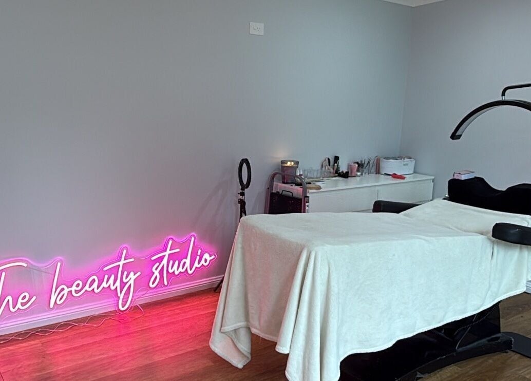 Treatment room at The Beauty Studio, Wilberforce, New South Wales, AU with neon sign and treatment bed.