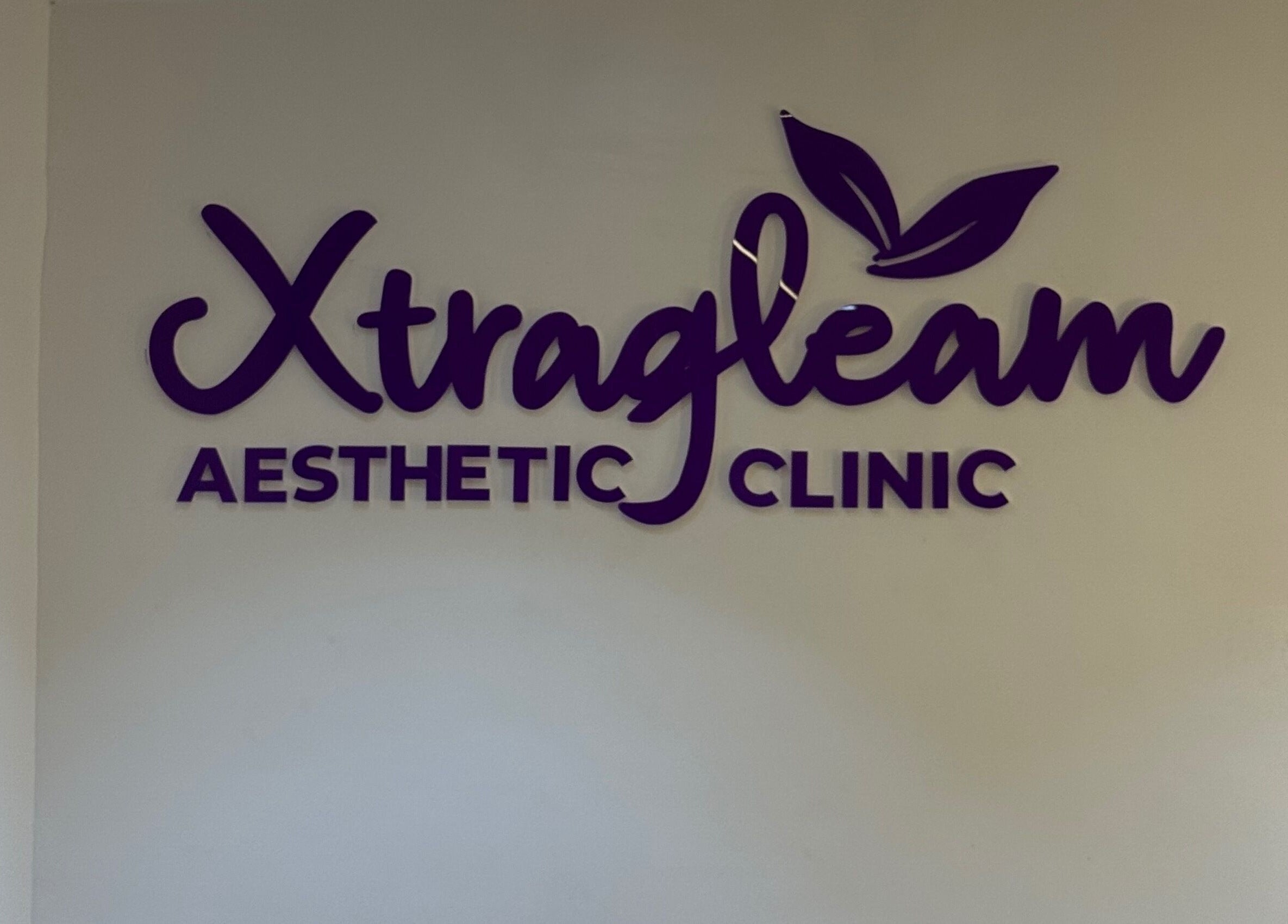 XTRAGLEAM AESTHETIC CLINIC (LAGOS) wall signage in Agege, Lagos, NG featuring bold purple letters.