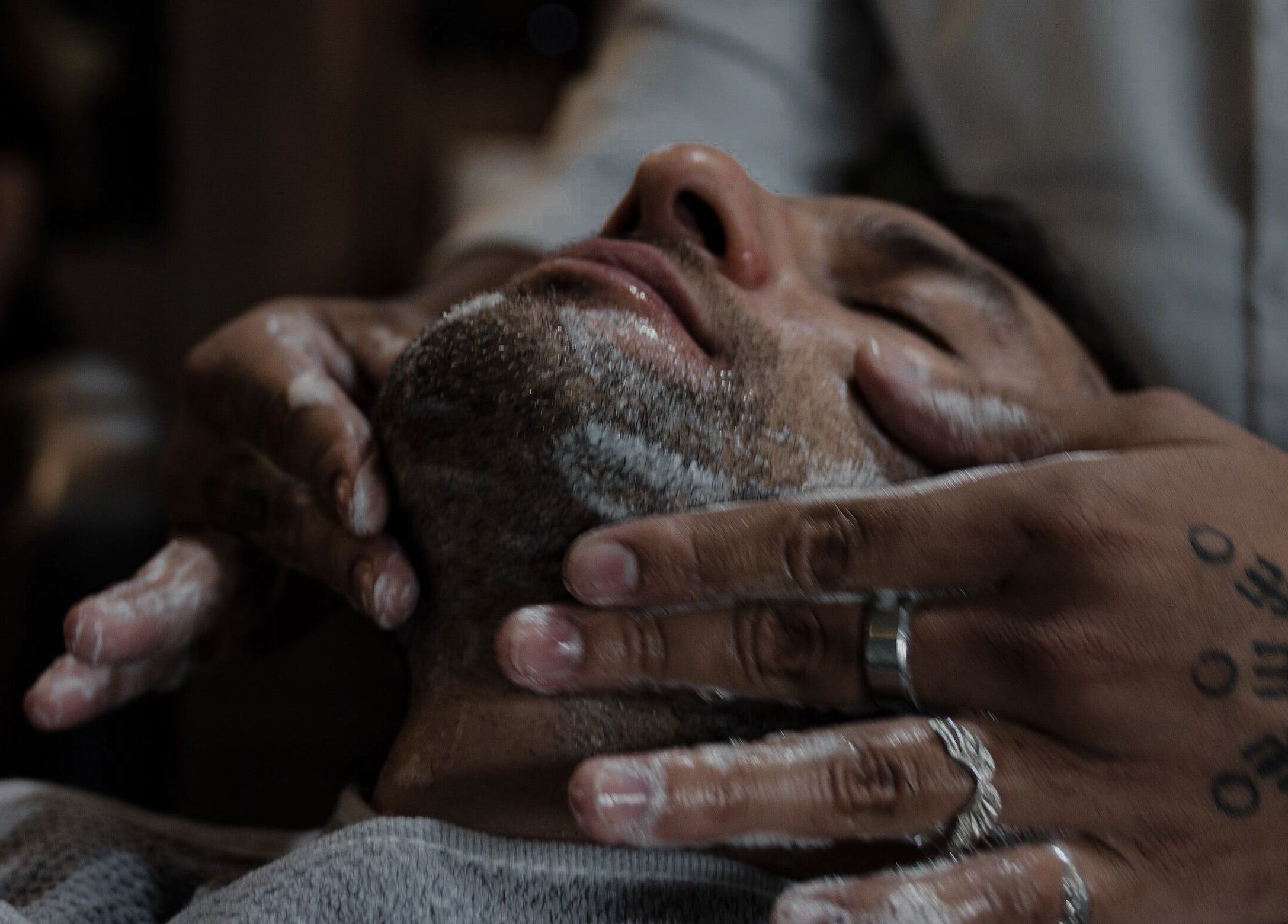 Close-up of a face massage at District Barber Society, Naucalpan De Juárez, Estado De México, MX.