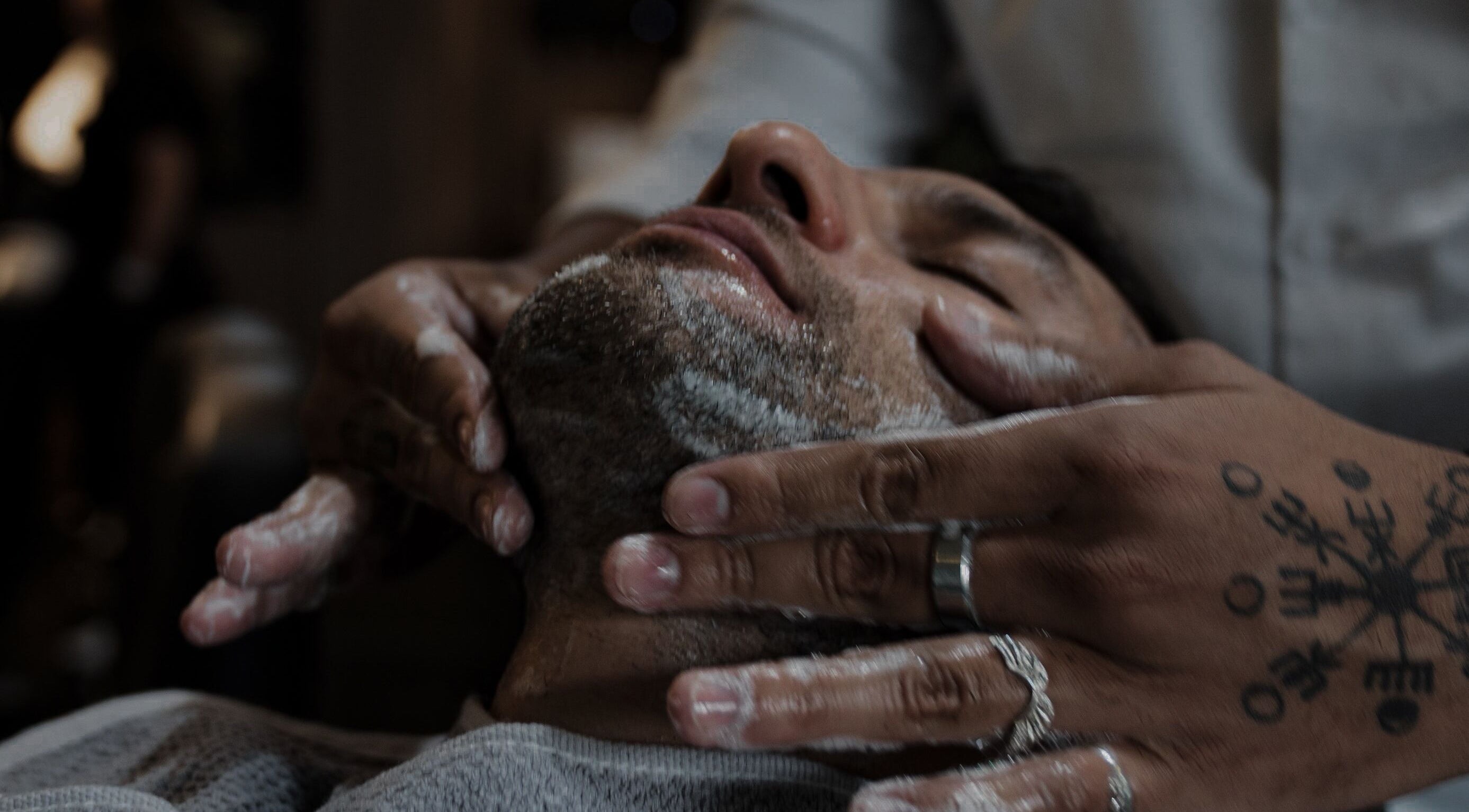 Close-up of a face massage at District Barber Society, Naucalpan De Juárez, Estado De México, MX.