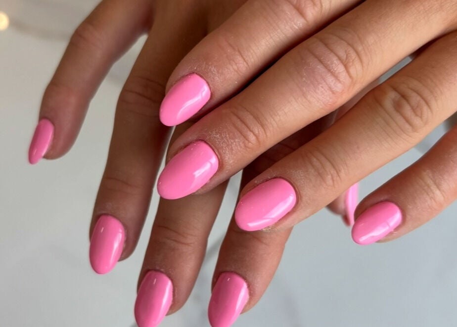 Pink manicured nails at With Love, Highcliffe, England, GB, showcasing expert nail art and care.