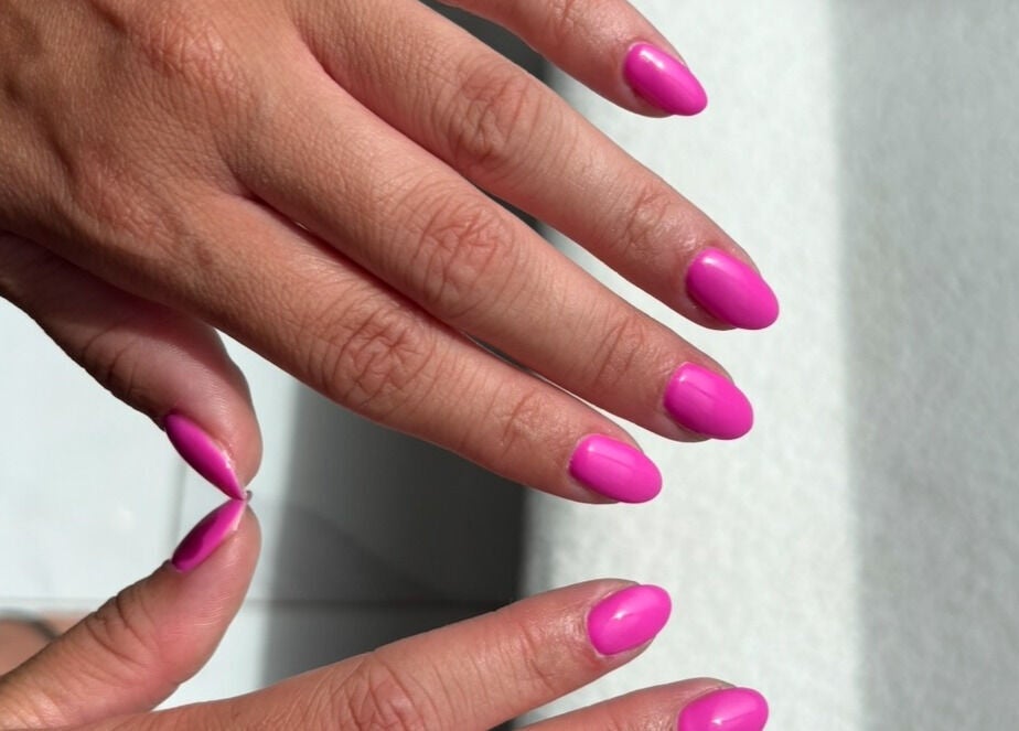 Vibrant pink manicured nails at With Love, Highcliffe, England, GB, showcasing professional beauty services.
