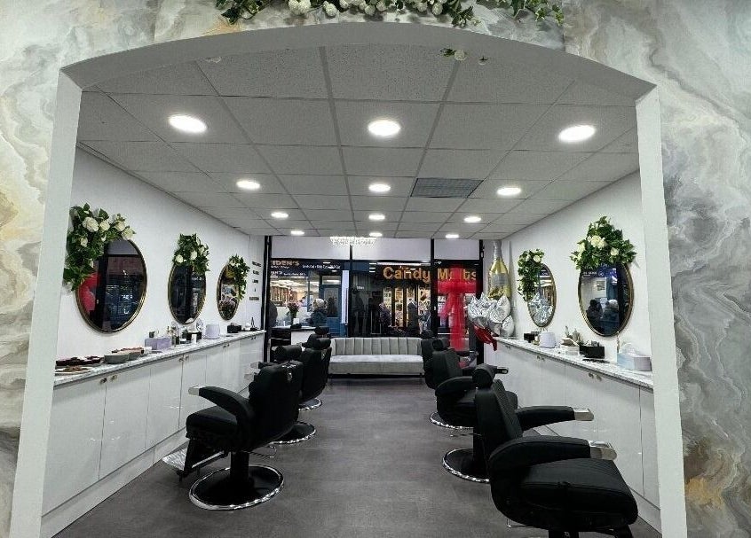 Elegant interior of Olympus Hair in Chester, England, GB, featuring stylish salon chairs and vibrant decor.