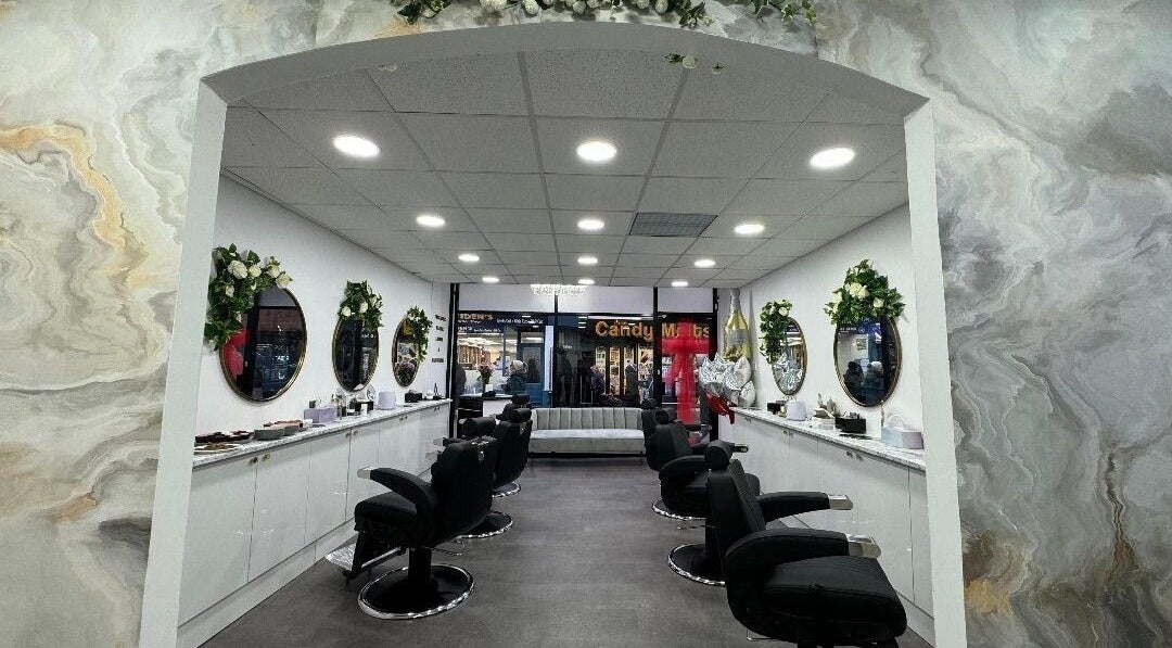 Elegant interior of Olympus Hair in Chester, England, GB, featuring stylish salon chairs and vibrant decor.